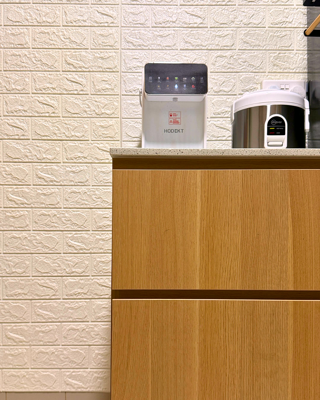 Kitchen counter detail against a textured white wall.