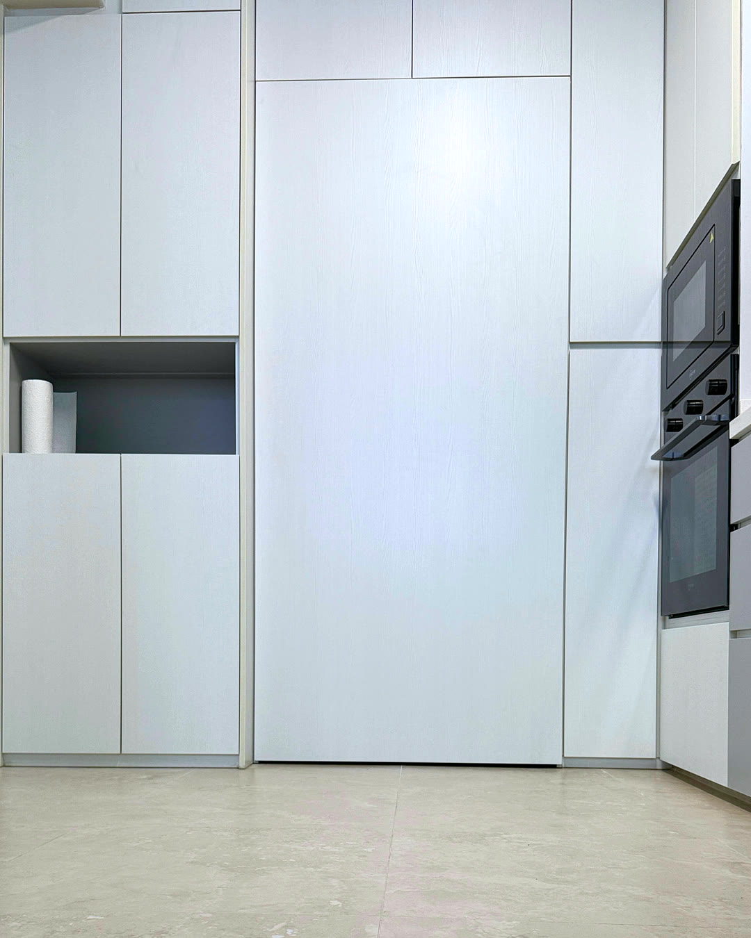Full-height white wardrobe with an open display shelf.